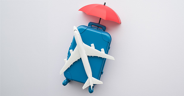 umbrella hovering over travel images to symbolize safety